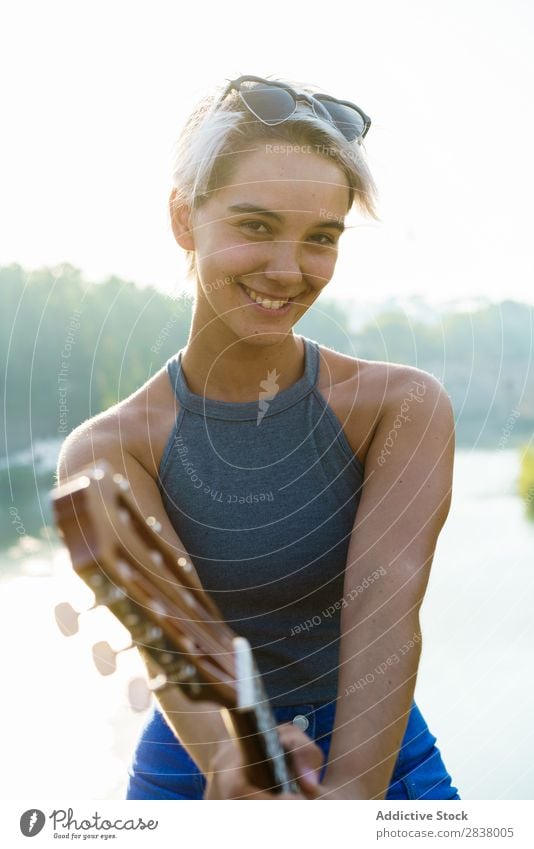 Girl posing with small guitar at street Woman Street Entertainment Ukulele Musician City Lifestyle Style Summer Leisure and hobbies Beauty Photography