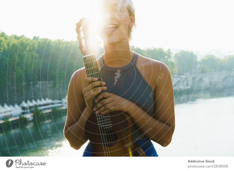 Girl posing with small guitar at street Woman Street Entertainment Ukulele Musician City Lifestyle Style Summer Leisure and hobbies Beauty Photography