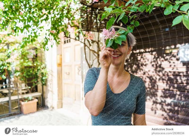 Woman covering face with flower Street Flower Tree Blooming Posture Joy Cheerful Summer Spring City Attractive Girl Beautiful Hair Happy Youth (Young adults)