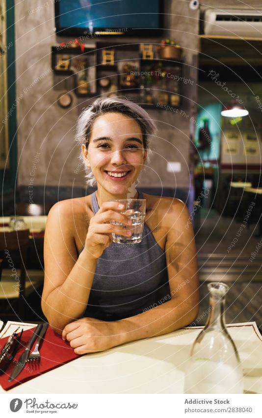 Young woman with drink in bar Woman Bar Posture Feasts & Celebrations Easygoing Drinking Relaxation Interior design Pub Beauty Photography Beverage Glass