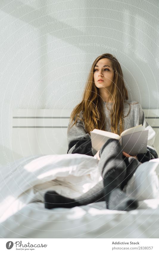 Girl chilling with book in cozy bed Woman Bed Reading Morning Book concentrated Serene Sunlight Peaceful Blonde Safety (feeling of) Home Room Resting To enjoy