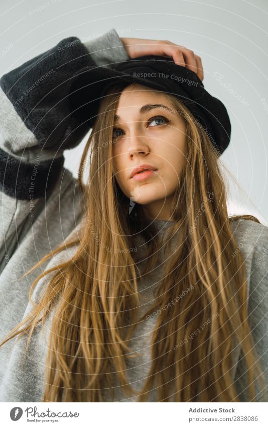 Stylish young girl sitting on bed Woman Dream Bed Style Relaxation Sweater Hat To enjoy Posture Window White Considerate Bedroom Rest long hair Contentment