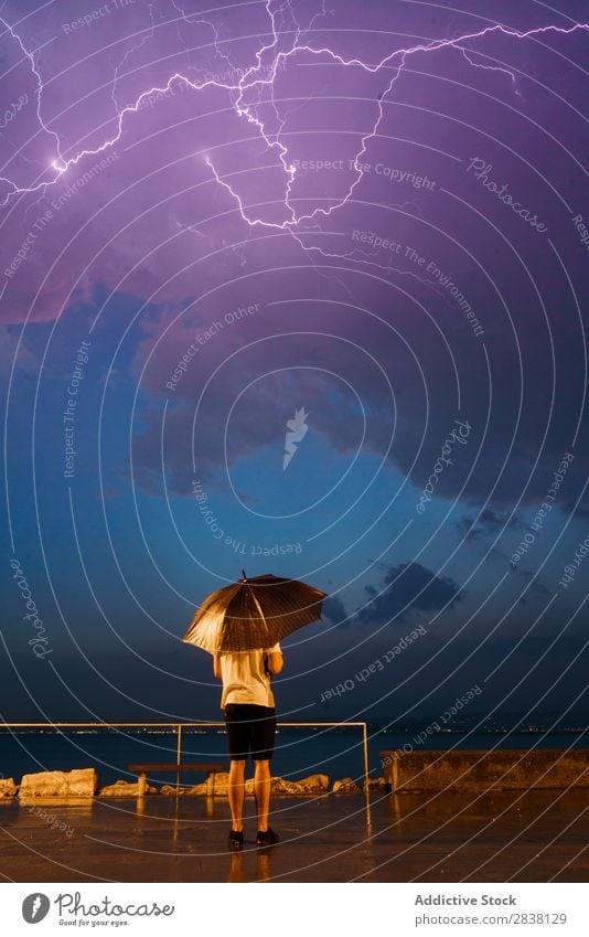 Man with umbrella under stormy sky Umbrella Thunder Storm Embankment Weather Rain Victoria & Albert Waterfront Thunder and lightning Lightning Natural Traveling