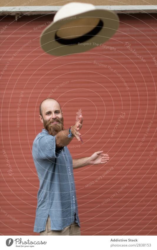 Man throwing hat on wall bearded Style Posture Considerate Youth (Young adults) Hair and hairstyles handsome Masculine Appearance Vertical Easygoing