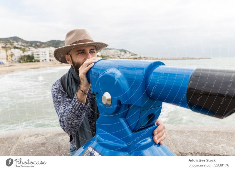 Man aiming with binoscope Tourist Binoculars Coast Ocean seaside Vacation & Travel Leisure and hobbies Adventure Youth (Young adults) Hat bearded handsome