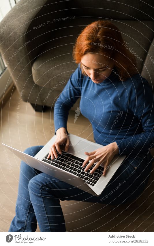 Woman surfing the laptop on a floor Notebook browsing using Surfing Gadget Technology device Sit Story Pensive pretty Self-confident Considerate Beautiful