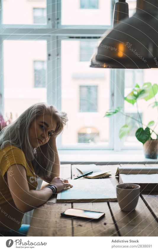 Woman with book at table pretty Home Youth (Young adults) Blonde Pensive Think Sit Table Book Map Lanes & trails Beautiful Lifestyle Beauty Photography