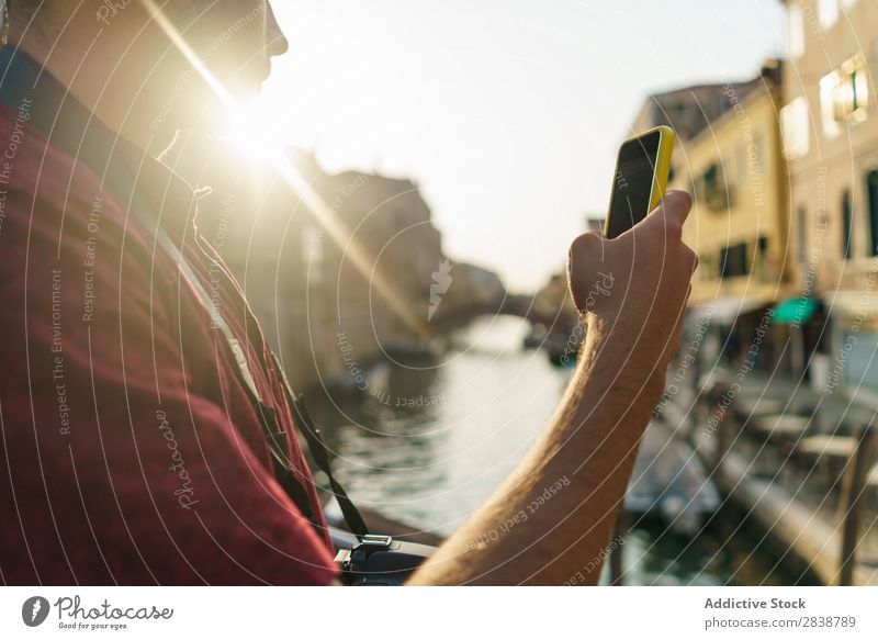 Man browsing smartphone on street PDA Vacation & Travel Channel Attraction Landmark romantic Vantage point Tourist Skyline Architecture City heritage Summer