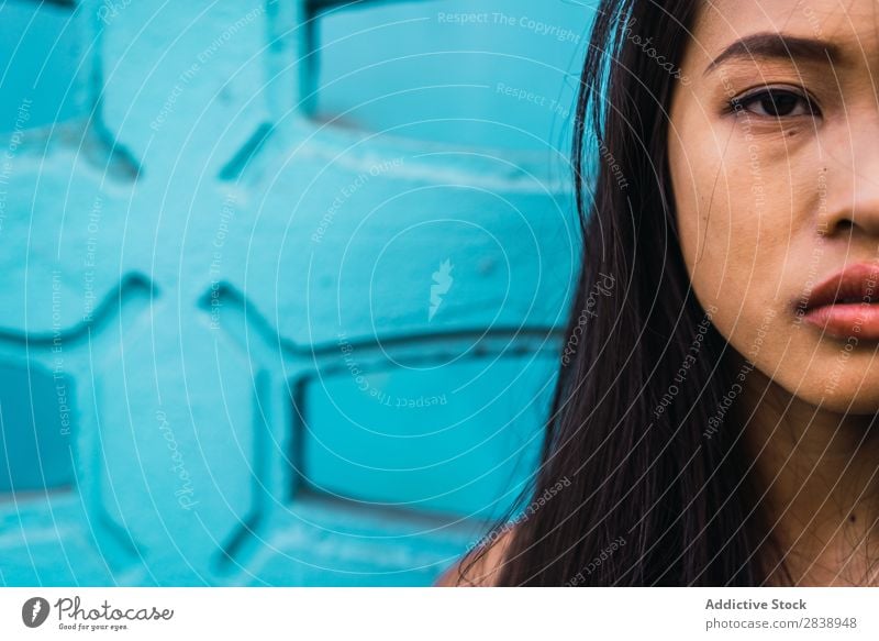 Thoughtful Asian woman leaning on blue door Woman pretty asian Youth (Young adults) Considerate Pensive Cloth Lean Street Town Beautiful Portrait photograph