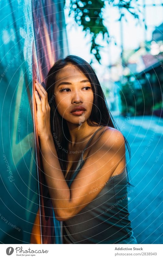 Thoughtful Asian woman leaning on blue door Woman pretty asian Youth (Young adults) Considerate Pensive Cloth Lean Street Town Beautiful Portrait photograph