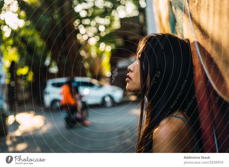 Thoughtful Asian woman on street Woman pretty asian Youth (Young adults) Considerate Pensive Cloth Lean Street Town Beautiful Looking away Portrait photograph