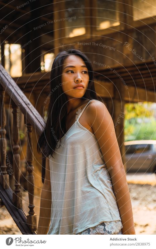 Thoughtful woman at wooden handrail Woman pretty asian Youth (Young adults) Considerate Pensive Lean Handrail Wood Looking away Beautiful Portrait photograph