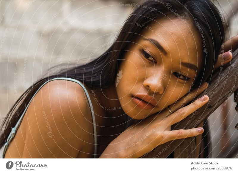 Thoughtful woman at wooden handrail Woman pretty asian Youth (Young adults) Considerate Pensive Lean Handrail Wood Looking away Beautiful Portrait photograph