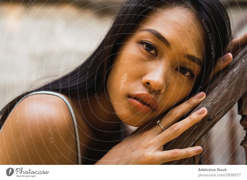 Thoughtful woman at wooden handrail Woman pretty asian Youth (Young adults) Considerate Pensive Lean Handrail Wood Beautiful Portrait photograph Attractive