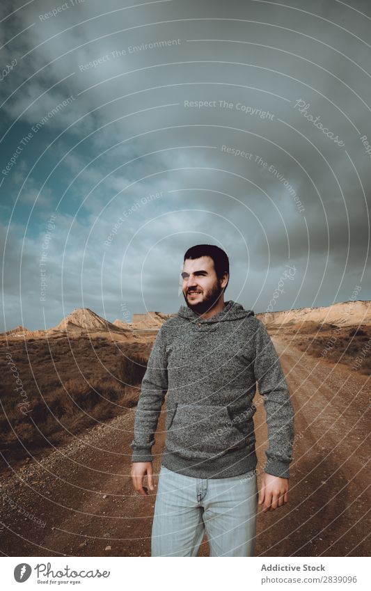 Cheerful man on dry road Human being Tourist Nature Dry Smiling Man Street Landscape Desert Landing Grass Sand Ground Environment Vacation & Travel Tourism