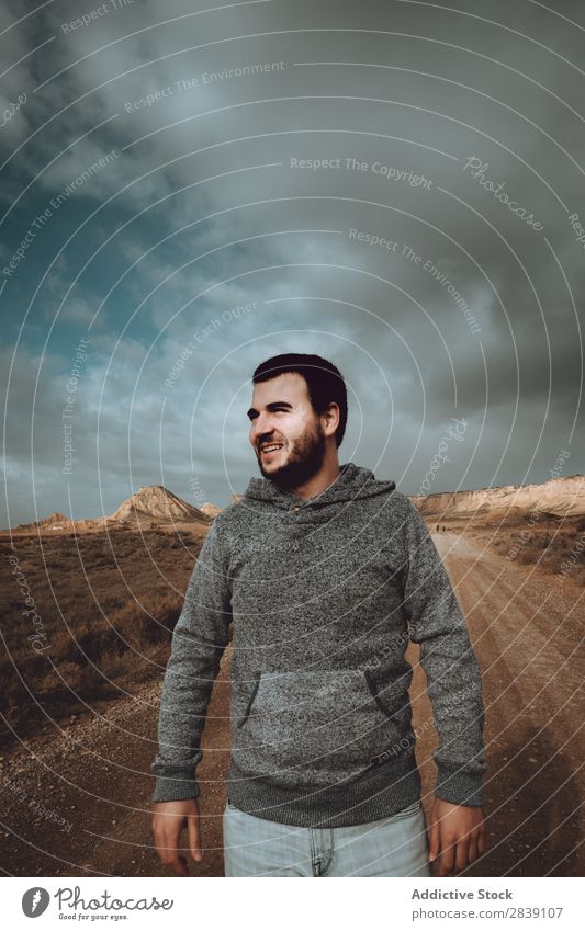 Cheerful man on dry road Human being Tourist Nature Dry Smiling Man Street Landscape Desert Landing Grass Sand Ground Environment Vacation & Travel Tourism