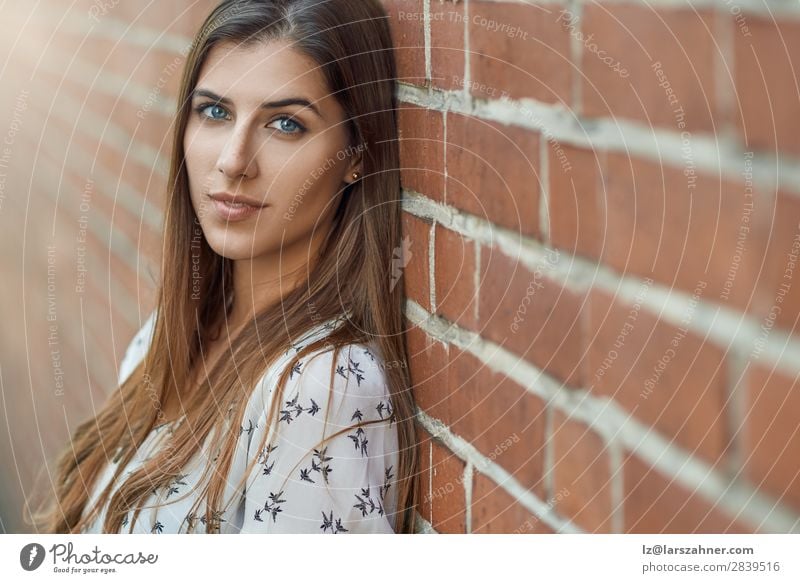 Portrait of young pretty woman near brick wall Lifestyle Joy Happy Beautiful Face Woman Adults 1 Human being 18 - 30 years Youth (Young adults) Nature Autumn