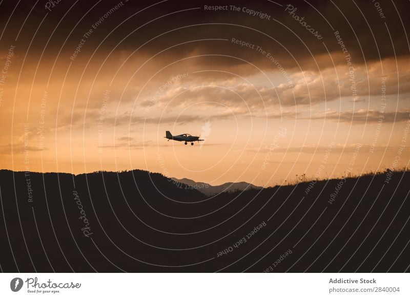 Silhouette of plane in air Landscape Airplane Mountain Sunset Clouds Majestic Tourism Serene Inspiration Transport Aviation Trip Highlands Haze Sky Aircraft