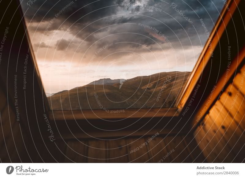 View of mountains through window Landscape Mountain Window Picturesque Dramatic Sunlight Environment Idyll Cloud cover Interior design Freedom Interior shot