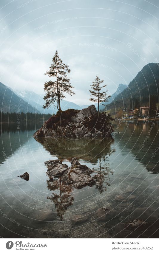 Rocks with trees in lake Mountain Lake Tree Island Landscape Reflection scenery Panorama (Format) Tourism tranquil Adventure Peaceful Valley Natural Wilderness