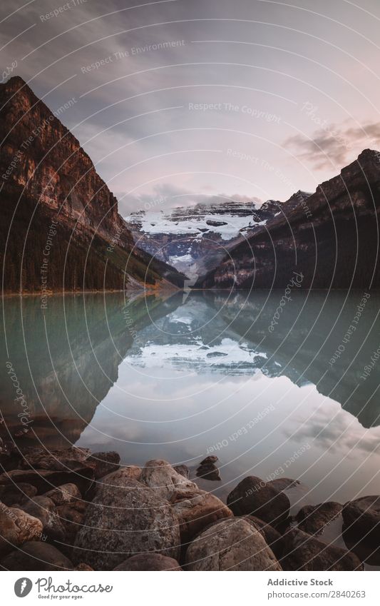 Reflection of mountains in lake Mountain Lake Valley Tourism Landscape Mirror Panorama (Format) Surface Nature Snow Rock tranquil Sky Majestic Environment