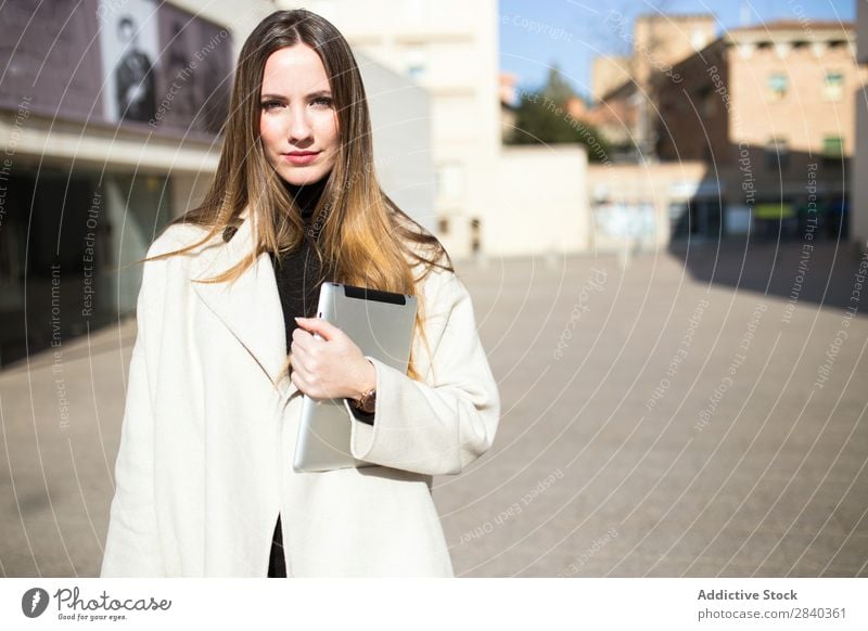 Elegant businesswoman in the street Woman Tablet computer Street Business Youth (Young adults) Businesswoman Looking into the camera Portrait photograph City