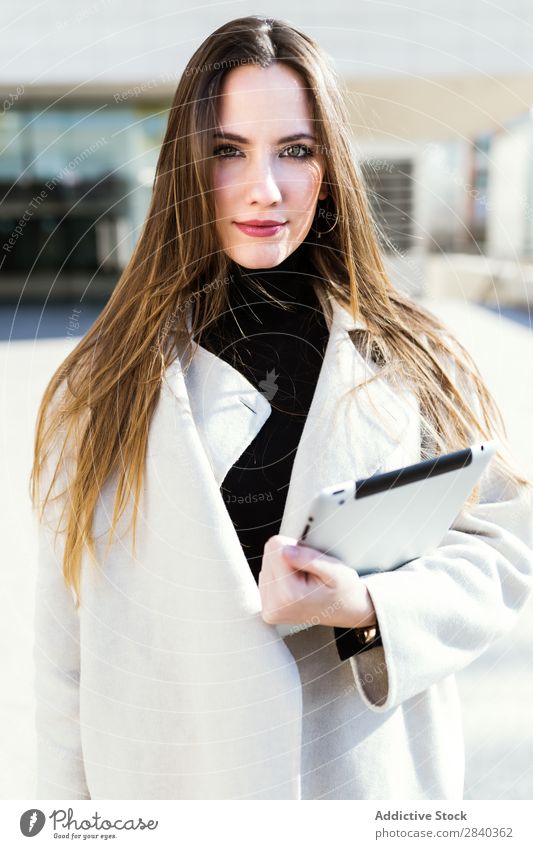 Elegant businesswoman in the street Woman Tablet computer Street Business Youth (Young adults) Businesswoman Looking into the camera Portrait photograph City