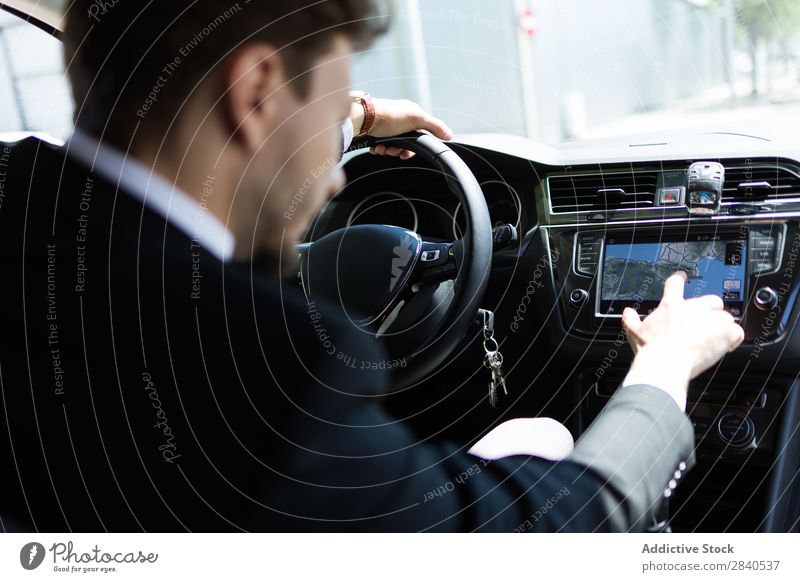 Man using navigator in car Car Navigation Businessman Technology Direction Transport Suit Vacation & Travel Driver touchscreen System Modern Street Vehicle