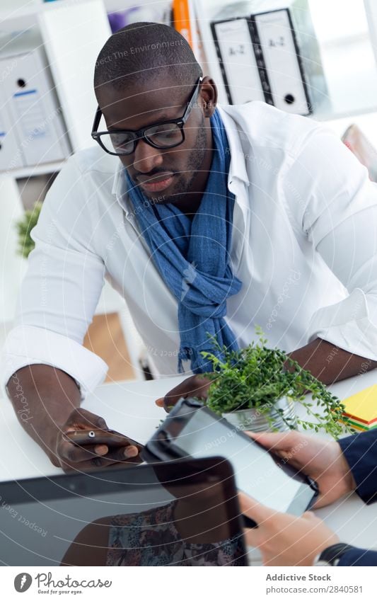 Young beautiful men working in the office. Business Work and employment Notebook Group Youth (Young adults) Businessman Team Teamwork Light Portrait photograph