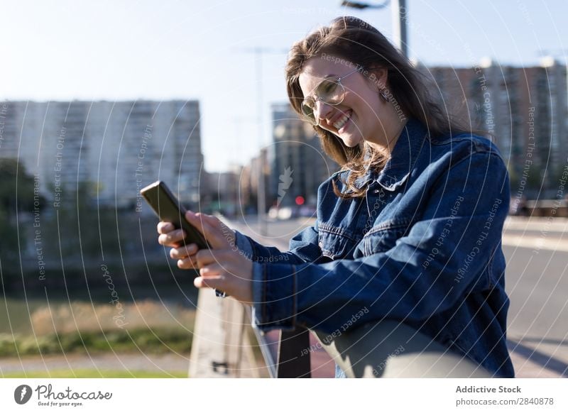 Smiling woman on road with phone Woman Walking Street Crossing Town Sunglasses Happy Joy Human being City Youth (Young adults) Girl Beautiful Going