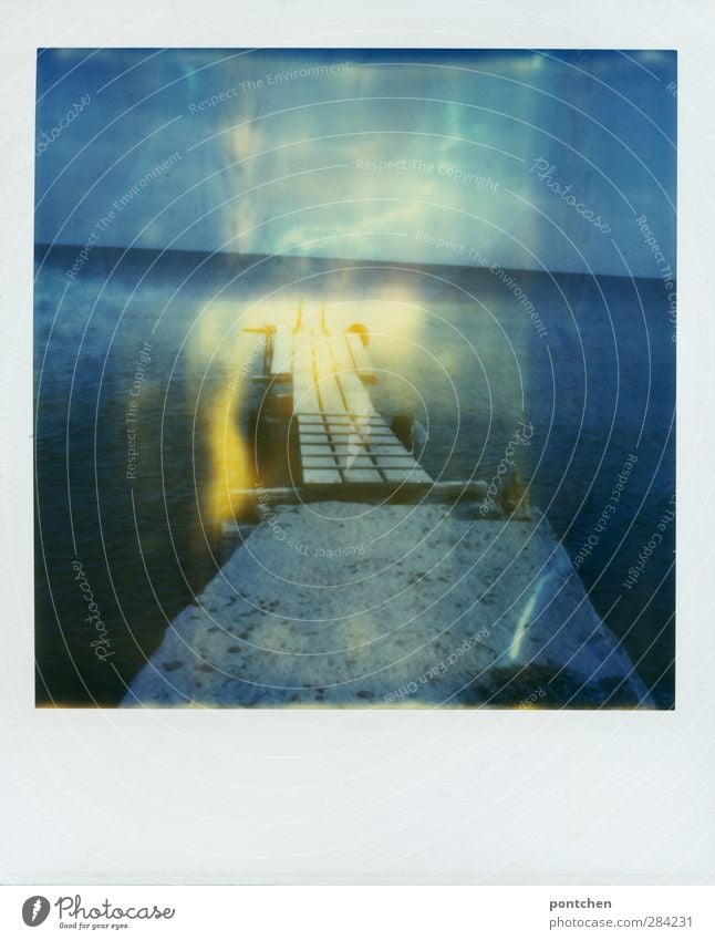 Polaroid. Wooden catwalk leads into the sea. Nature Water Sky Summer Coast Ocean Blue Footbridge Duck Tilt Colour photo Exterior shot Copy Space bottom Day