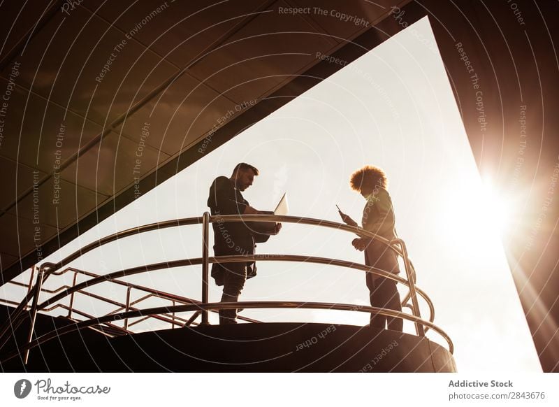 Couple with laptop at handrail Adults Style Beautiful Stand Handrail Notebook Computer using Coat warm clothes Together handsome pretty Happiness boyfriend