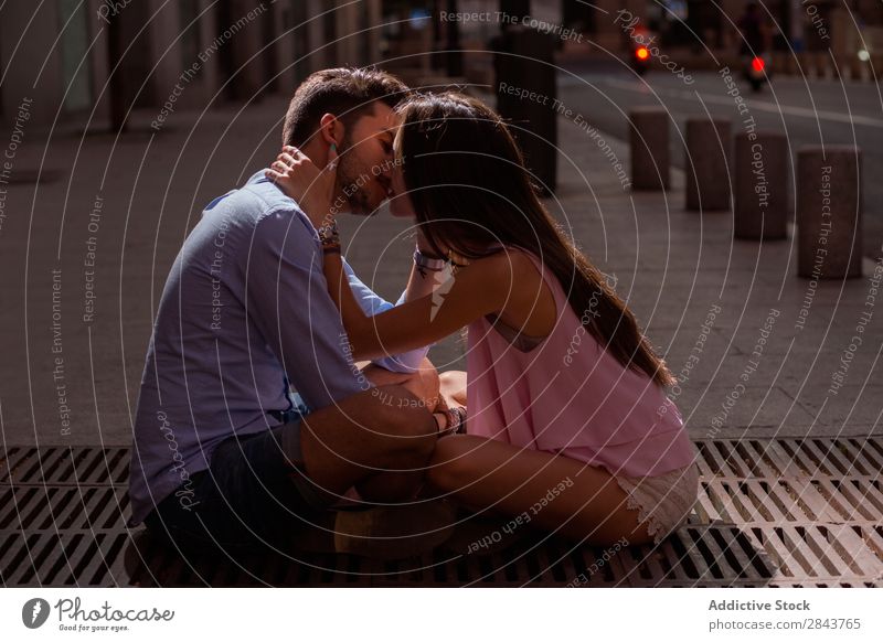 Portrait of beautiful couple in casual wear hugging in the street Couple Embrace Street Portrait photograph Looking into the camera Passion Kissing Brunette