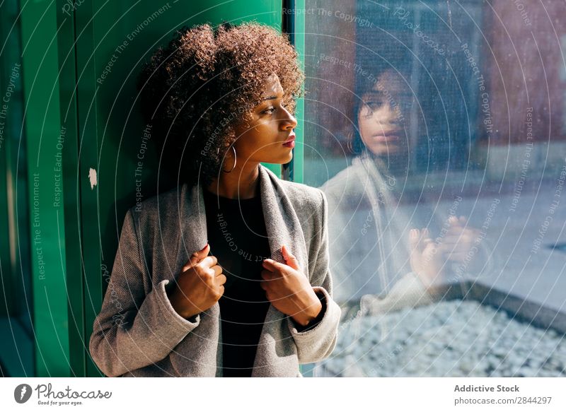 Trendy black model looking in window Woman Style Window Pensive To enjoy Feminine Elegant looking out African Beauty Photography Posture Street Bright Sunlight