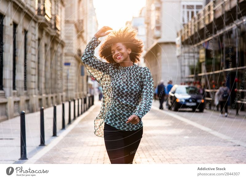 Cheerful ethnic woman walking at street Woman Happiness Dream Town Walking Success Style romantic Beauty Photography Street Feminine Posture Freedom Lifestyle