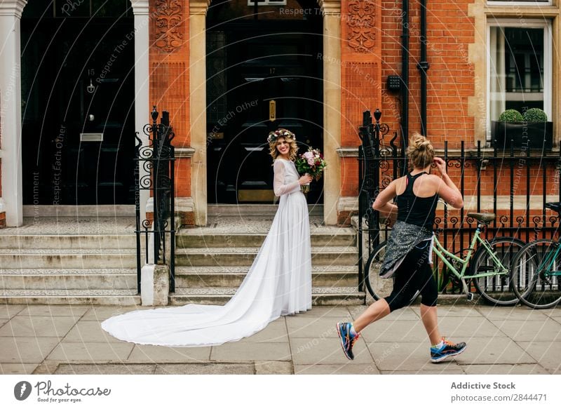 Passer-by person looking at bride Woman Bride Smock White chaplet passer-by sportsman Paper chain Wreath Flower bunch Bouquet Walking Veil Headdress Elegant