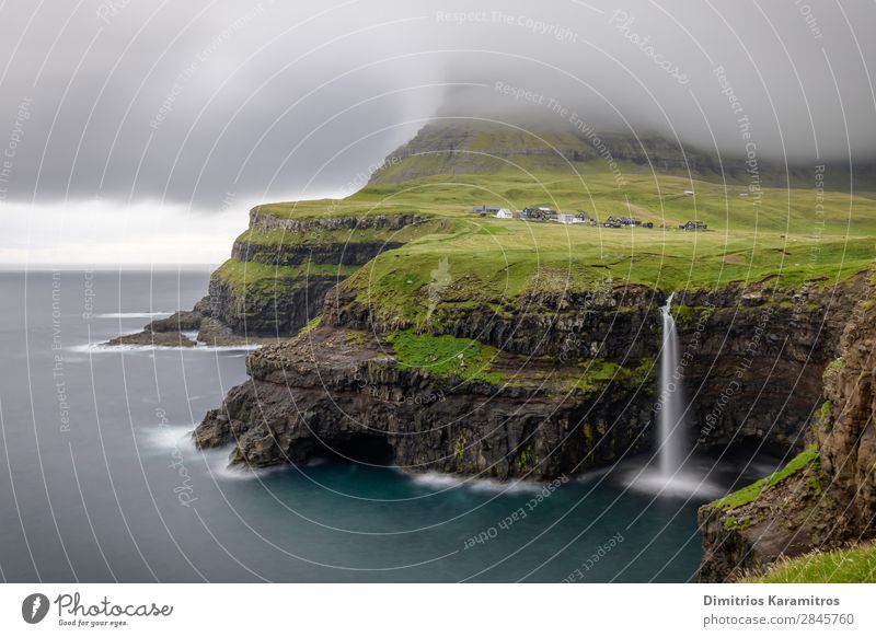 View of Mulafossur waterfall in Faroe Islands Environment Nature Landscape Sky Rock Mountain Waves Coast Waterfall Fishing village Discover Beautiful Wanderlust