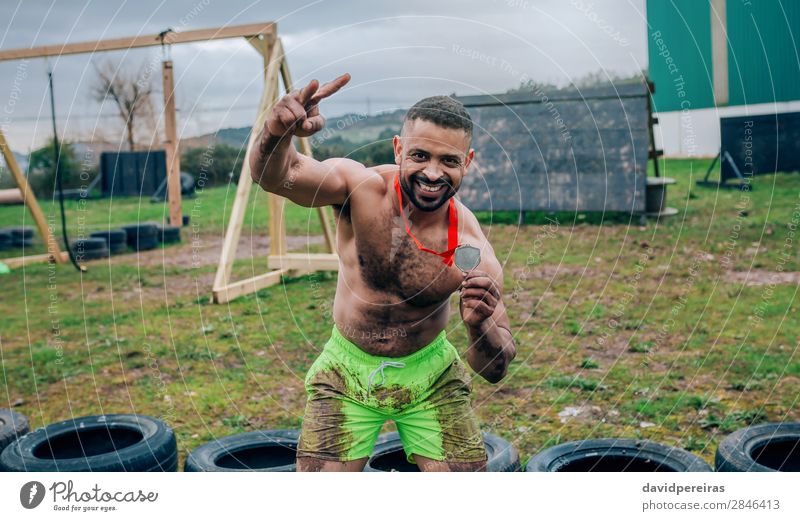 Male athlete showing medal after race Happy Feasts & Celebrations Sports Award ceremony Success Human being Man Adults Hand Smiling Authentic Muscular Strong