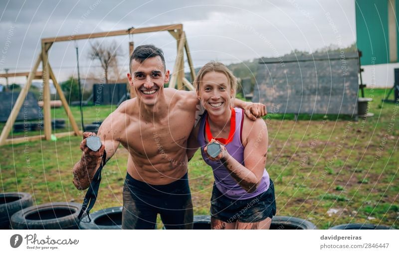 Couple showing medals after race Happy Playing Feasts & Celebrations Sports Award ceremony Success Human being Woman Adults Man Hand Smiling Authentic Happiness