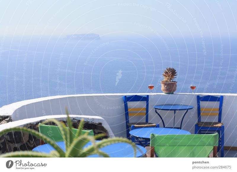 Santorini. Sea view from a terrace of a restaurant. Blue chairs, wine glasses, cactus. Typical Greek Lifestyle Tourism Bear Cocktail bar Water Sky Summer