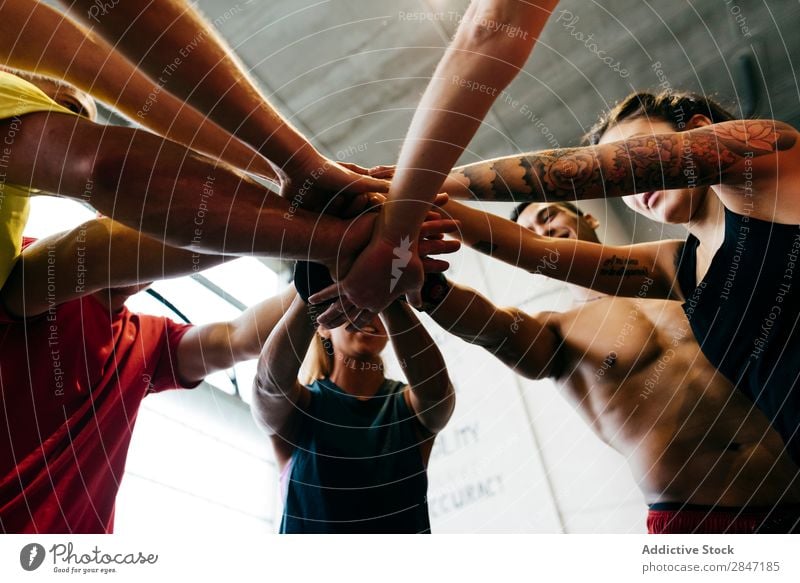 Sportive people stacking hands sportsmen Together Gymnasium Teamwork achievement unity Support Body building Cheerful Muscular Energy Determination Gesture