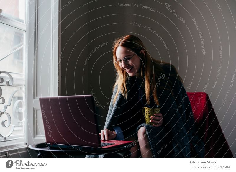 Woman in armchair using laptop and drinking coffee Home Youth (Young adults) Beautiful Considerate Pensive pretty Beauty Photography Happy Room Cute To enjoy