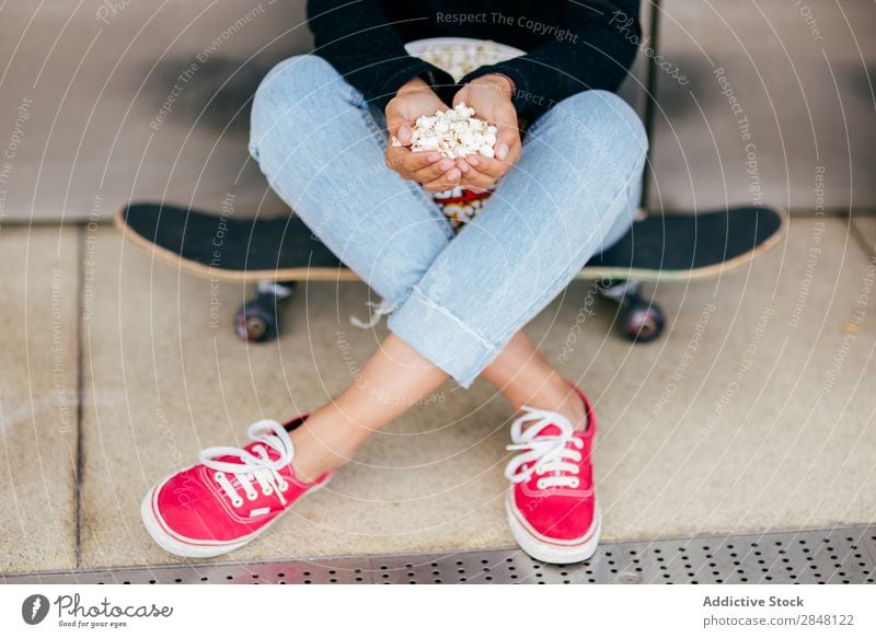 Crop woman with pile of popcorn Woman Popcorn Skateboard Town Accumulation Youth (Young adults) Snack Style Hold Clothing Hipster Bucket Culture Sit Posture