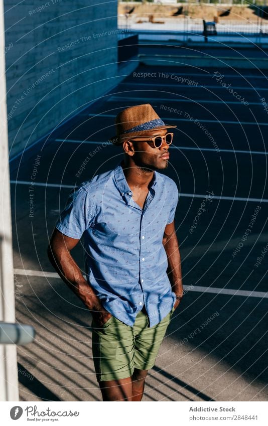 Stylish black man posing at street Man Style Summer Posture Hip & trendy Black Town Hipster Street Shirt Clothing fashionable handsome Masculine Easygoing Hat