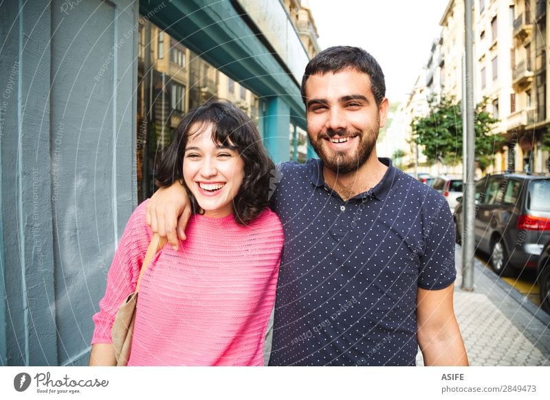 Young couple having fun on the street Lifestyle Shopping Joy Happy Beautiful Summer Hiking Woman Adults Man Friendship Couple Street T-shirt Sweater Beard