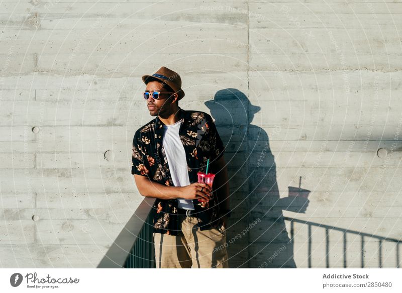 Thinking man standing and drinking Man City Self-confident Drinking Refreshment Sunglasses Looking away Human being Youth (Young adults) Professional Town