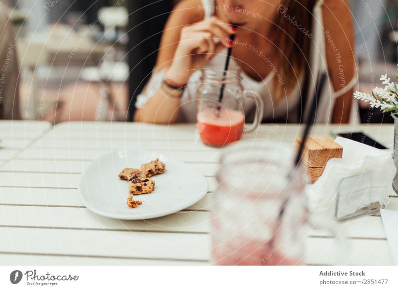 Girl drinking cocktail with cookie Woman Milkshake Cookie Snack Table Drinking Straw Cocktail Sweet Refreshment Natural blended Healthy Relaxation Chocolate