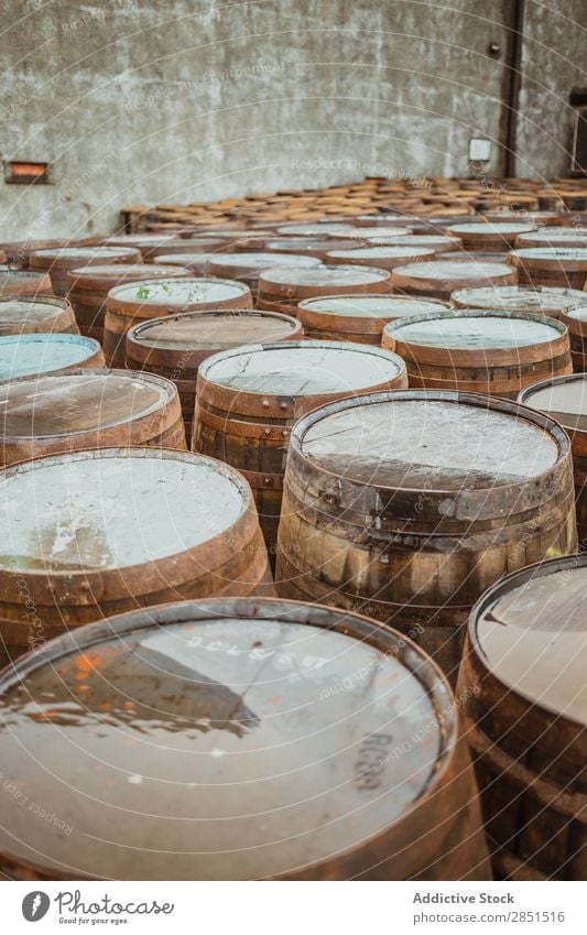 Wooden barrels on stone surface Arranged Winery Storage Production Factory Warehouse Alcoholic drinks Beverage Stack Collection Rustic Arrangement Pavement