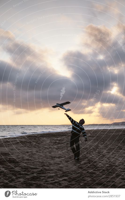 Man on a beach throwing the toy plane Human being Airplane Playing Throw Story Beach Happy Joy Toys Lifestyle Dream Childish Evening Coast Ocean Water Intellect