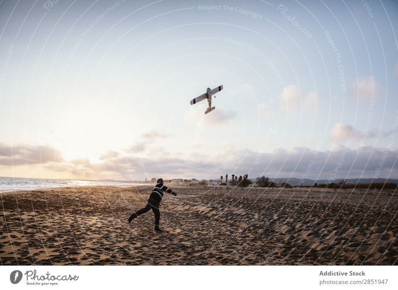 Man on a beach throwing the toy plane Human being Airplane Playing Throw Story Beach Happy Joy Toys Lifestyle Dream Childish Evening Coast Ocean Water Intellect